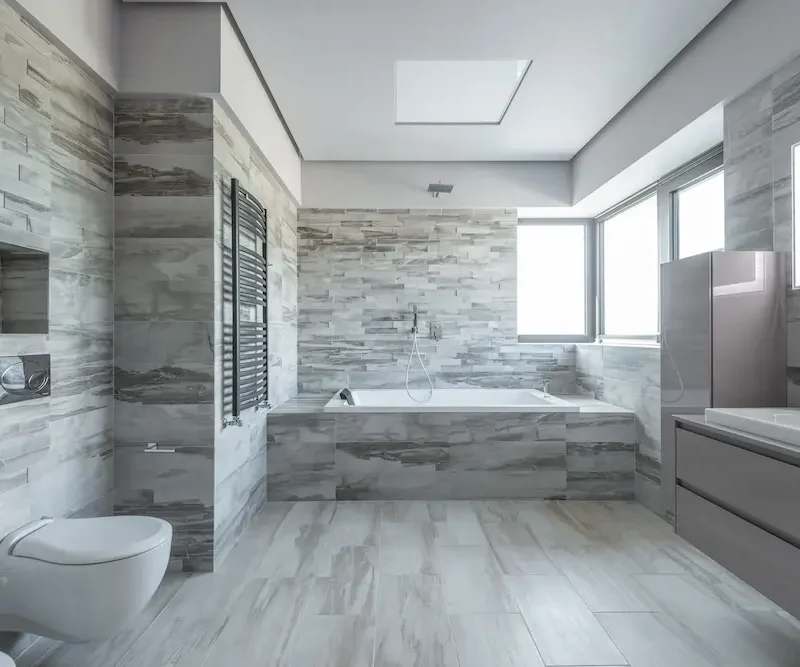 Contemporary ensuite bathroom with modern shower, vanity, and stylish tiled walls.